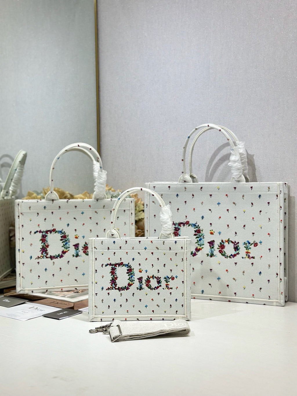 White Dior tote bags with multicolor speckled pattern and large 'Dior' print