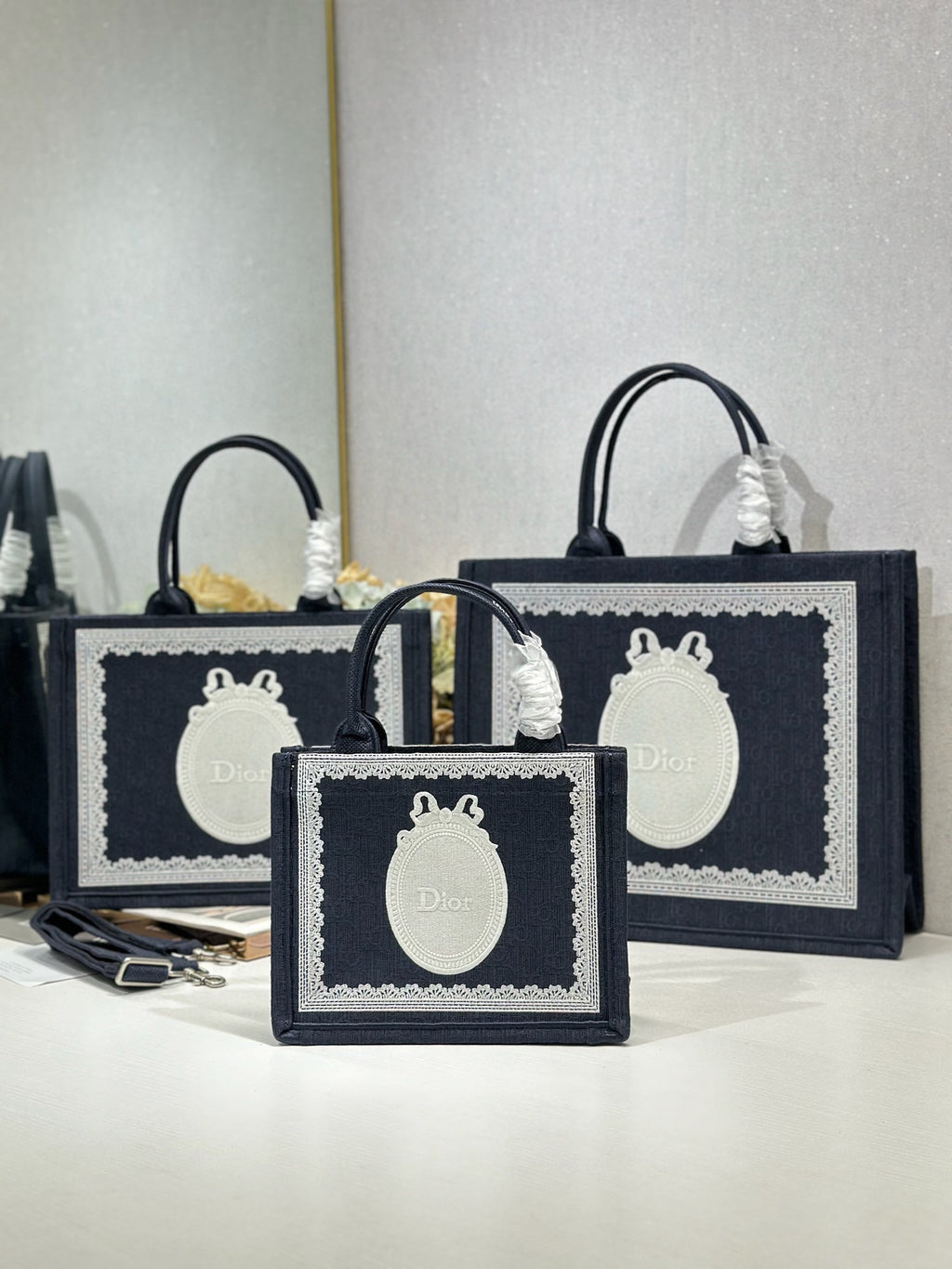 Navy Dior tote bag set with oval white logo plaques and top carry handles