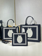 Navy Dior tote bag set with oval white logo plaques and top carry handles