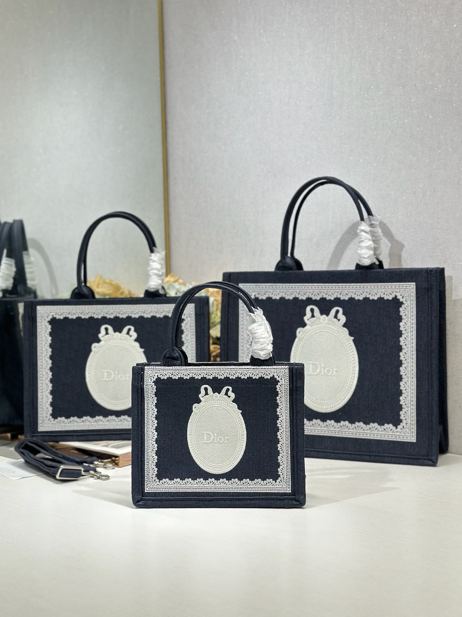 Navy Dior tote bag set with oval white logo plaques and top carry handles