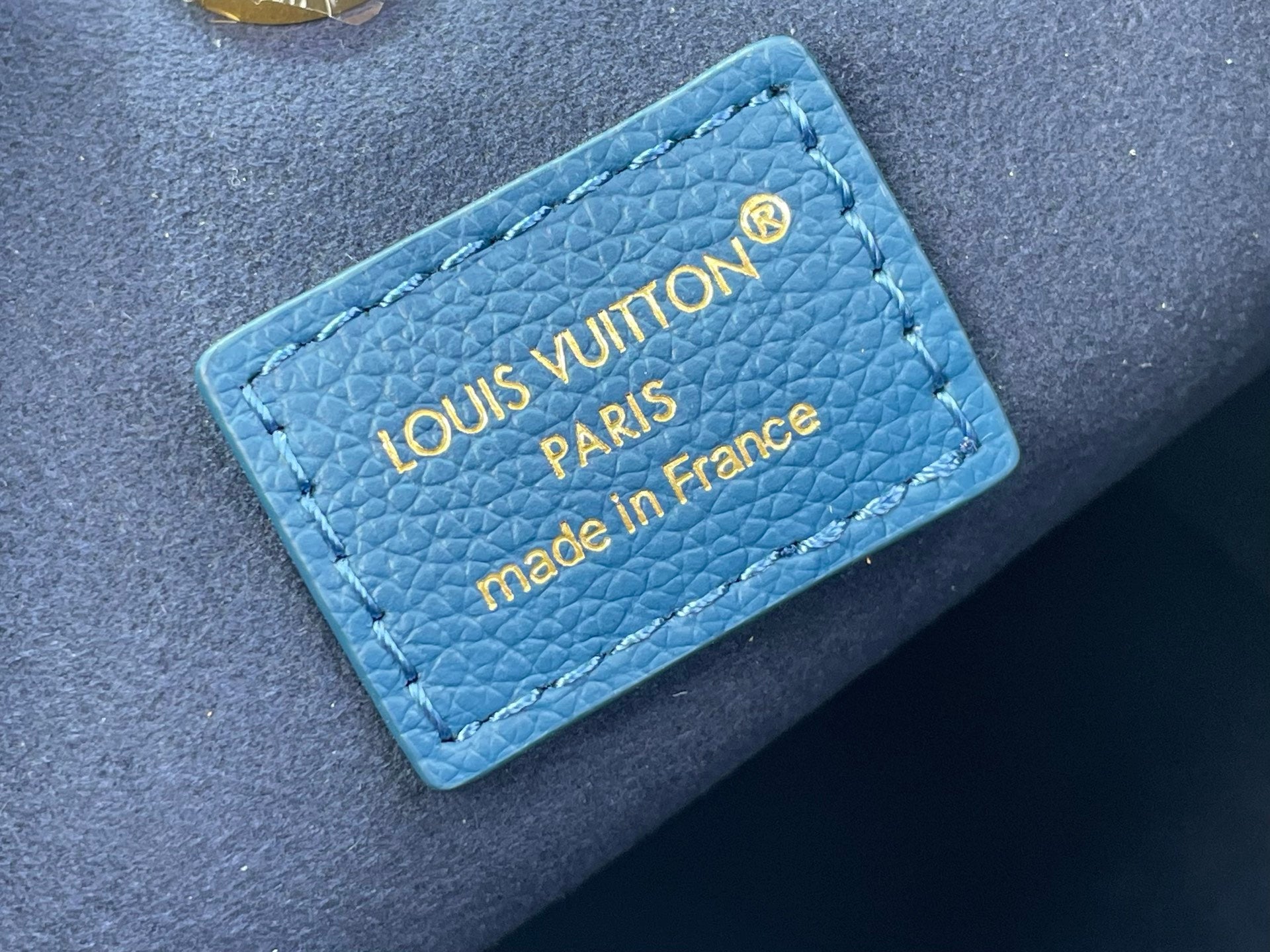 Blue leather bag tag with Louis Vuitton Paris text and made in France