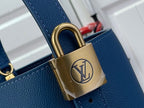 Blue leather bag with gold-tone padlock and chain hardware