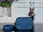 Blue flap crossbody bag with gold-tone studs and attached strap pouch