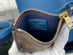 Blue-lined mini bag interior with gold zipper and inner logo patch