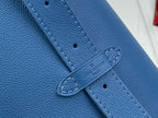 Louis Vuitton blue leather strap detail with stitched closure and embossed logo