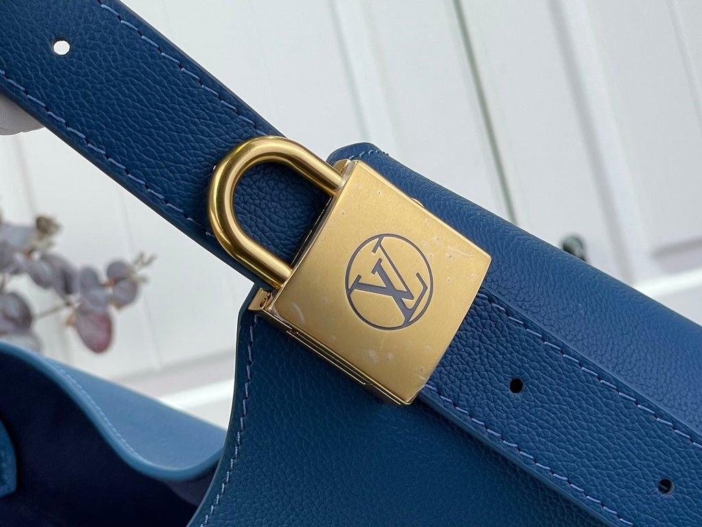 Louis Vuitton blue strap with gold padlock clasp and circular ring hardware