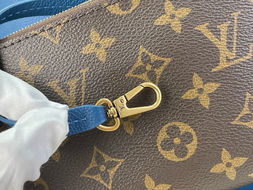 Louis Vuitton monogram wristlet clasp with gold hardware and blue strap