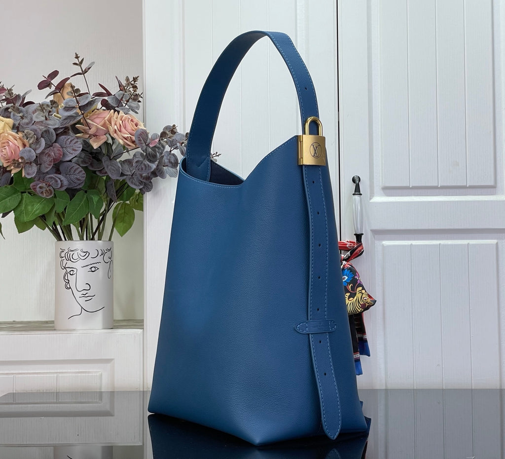 Louis Vuitton blue tote bag with top handle and adjustable shoulder strap