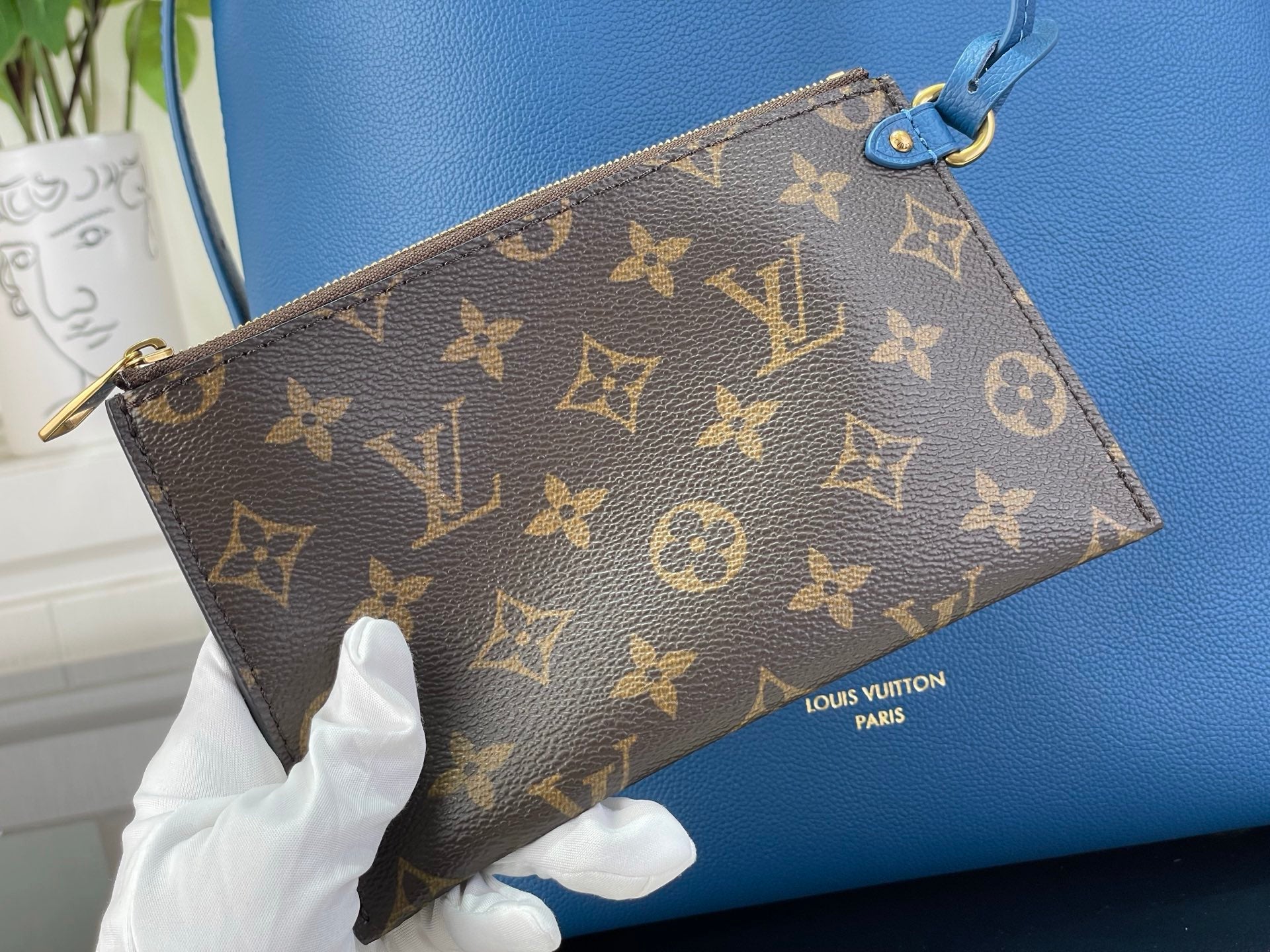 Louis Vuitton monogram wristlet pouch with zipper and blue leather strap