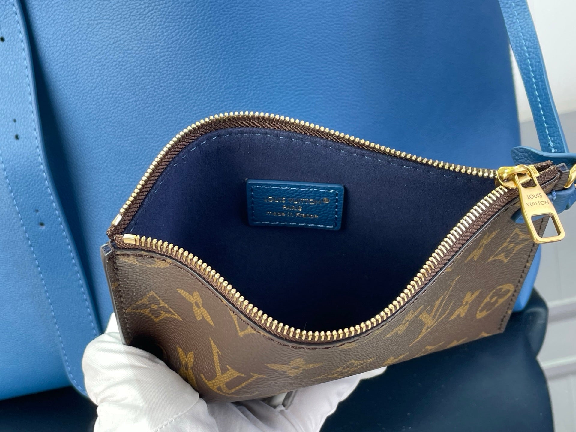 Louis Vuitton small bag with blue interior lining and gold zipper, brown monogram