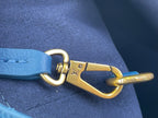 Louis Vuitton blue leather strap with gold hook clasp and LV charm