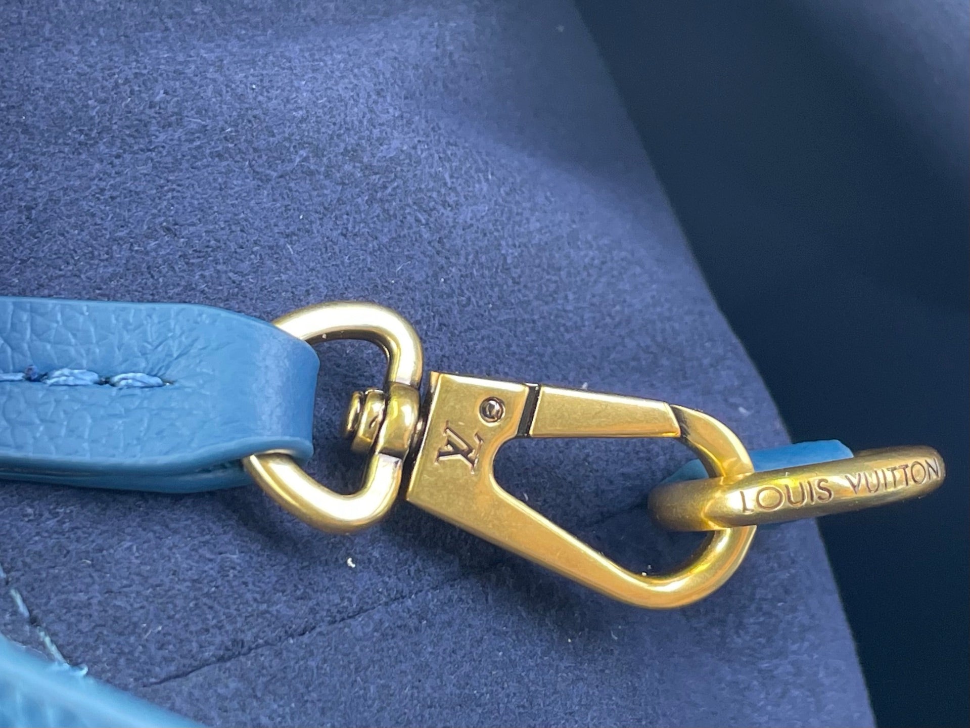 Louis Vuitton blue leather strap with gold hook clasp and LV charm