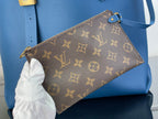 Louis Vuitton monogram pouch with gold zipper on blue tote bag