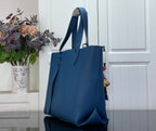 Louis Vuitton blue tote bag angled view with dual handles and structured shape