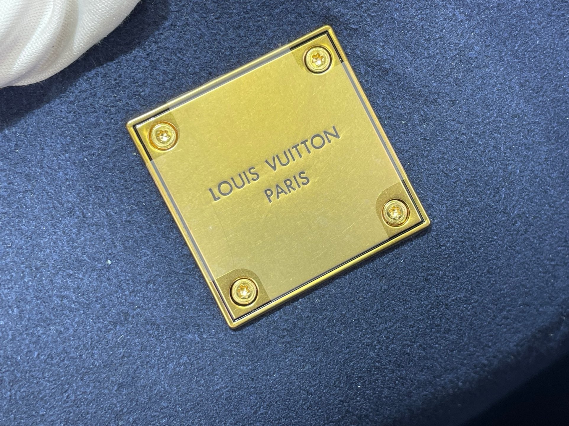 Louis Vuitton blue leather label with gold plate and “LOUIS VUITTON PARIS”