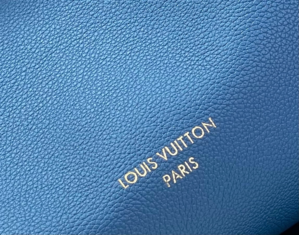 Louis Vuitton blue pebbled leather with debossed “LOUIS VUITTON PARIS” text