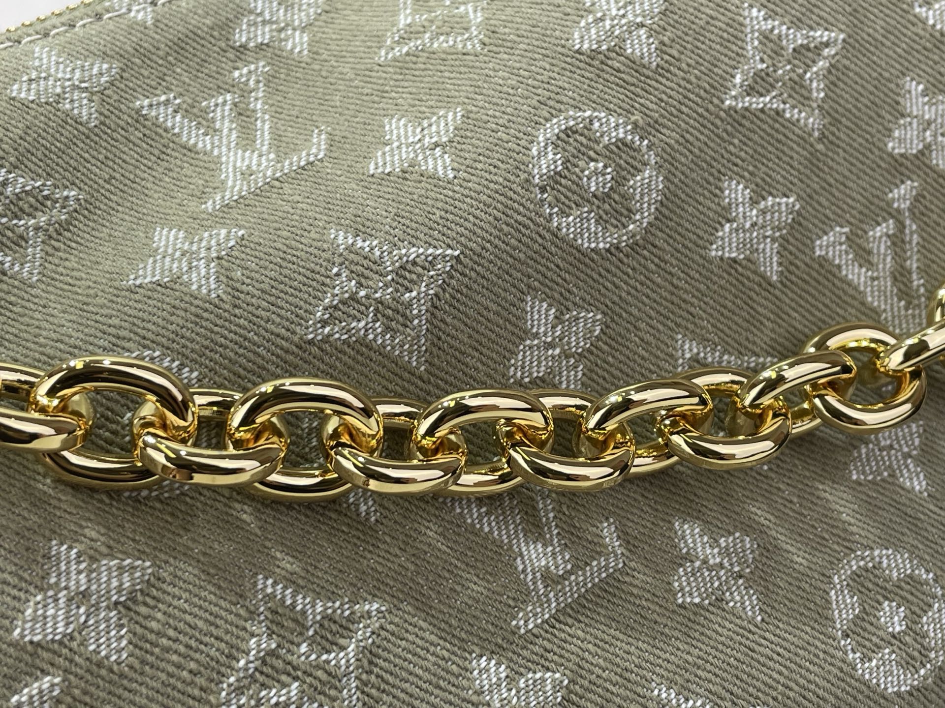 Gold-tone chain on Louis Vuitton monogram canvas handbag