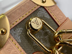 Louis Vuitton monogram clasp charm on gold-tone hardware with light leather strap
