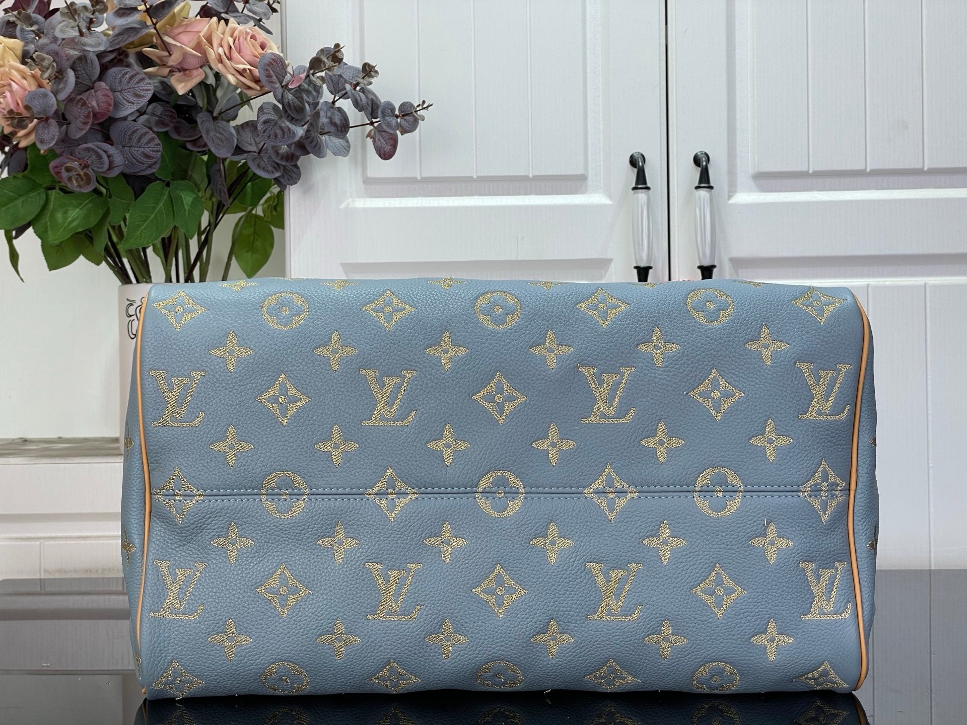 Louis Vuitton light blue monogram duffel-style bag with tan trim, front view