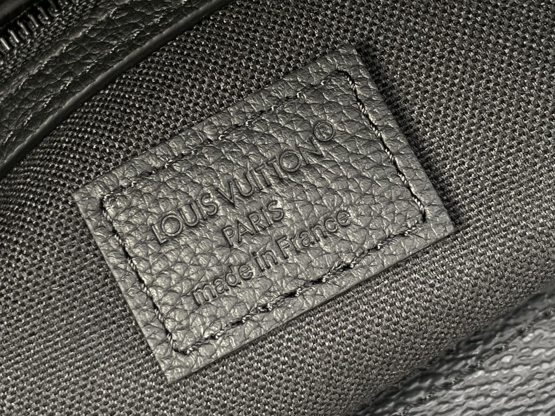 Louis Vuitton bag interior leather label with text