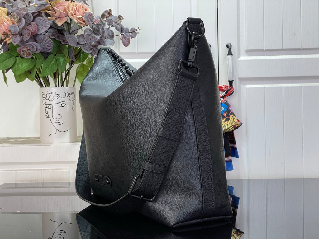 Louis Vuitton hobo bag angled view with front snap and side strap details