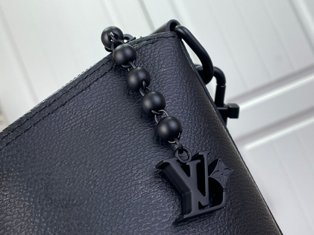 Louis Vuitton hobo bag close-up of top handle hardware with LV charm