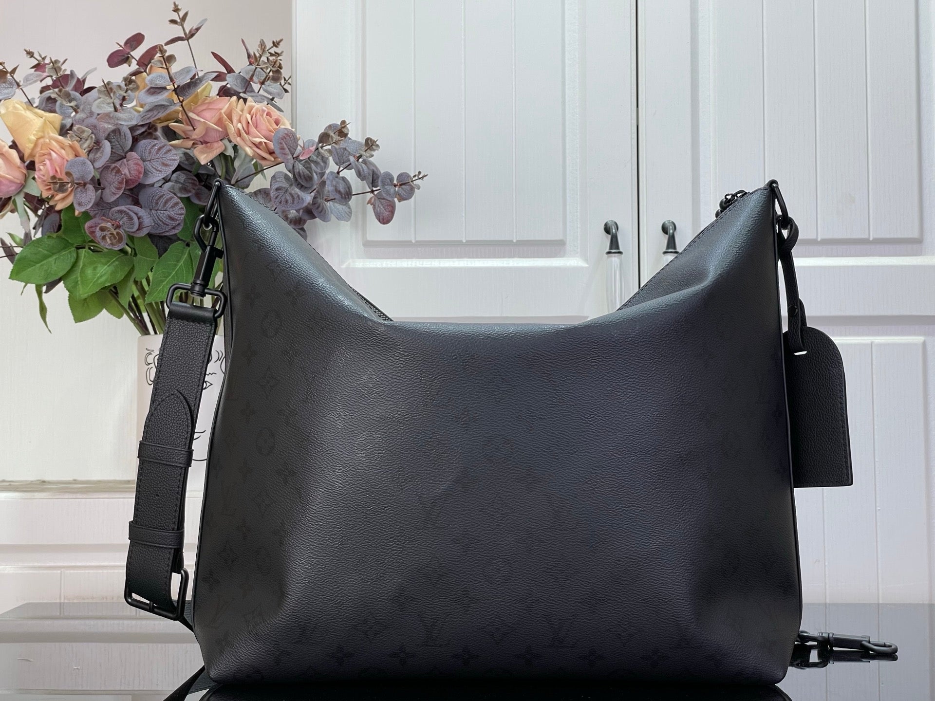Louis Vuitton hobo bag with adjustable shoulder strap and top zip closure