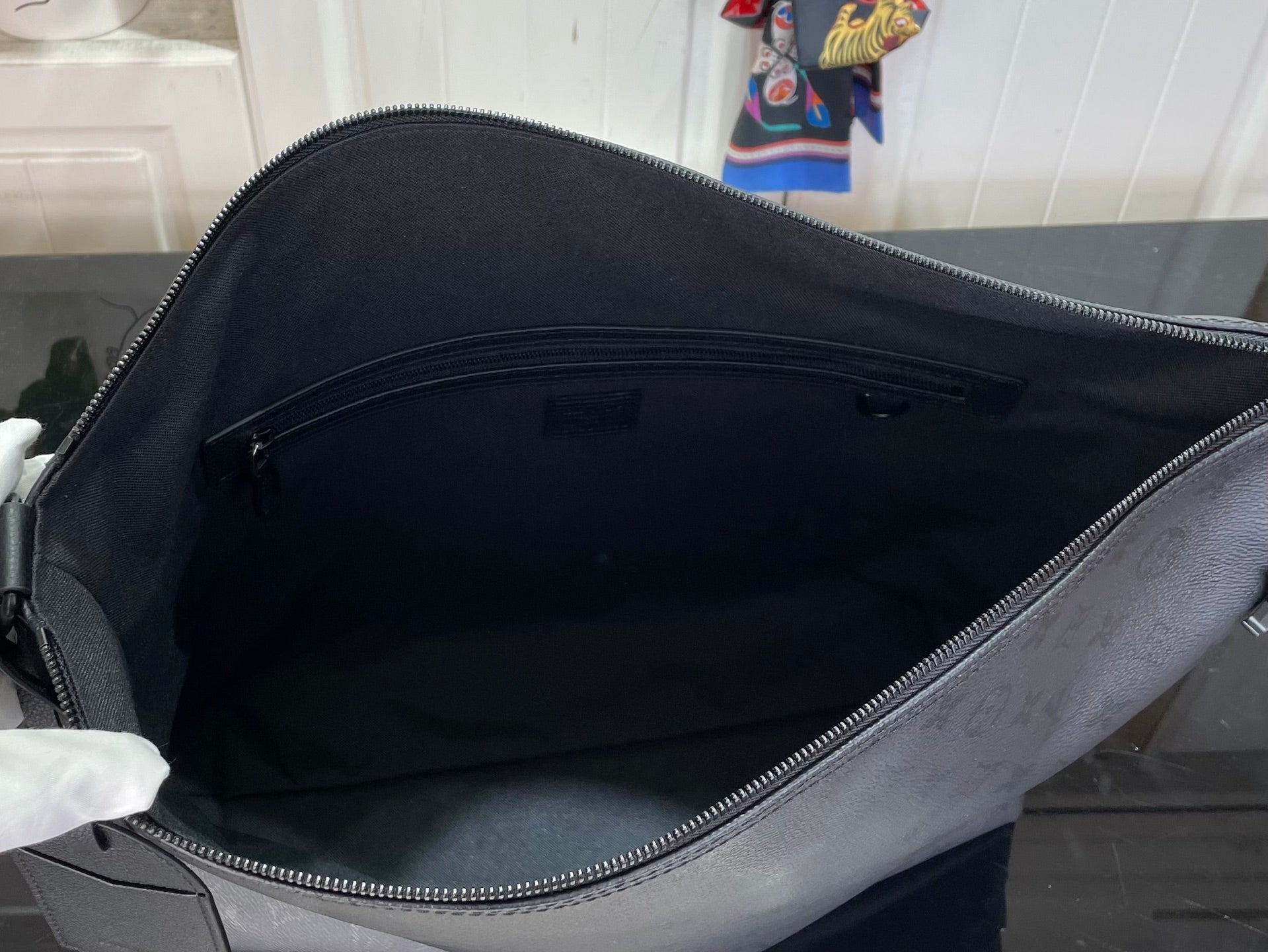 Louis Vuitton hobo bag open top showing dark fabric interior and zipper track