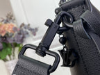 Louis Vuitton hobo bag close-up of strap hardware and hanging charm