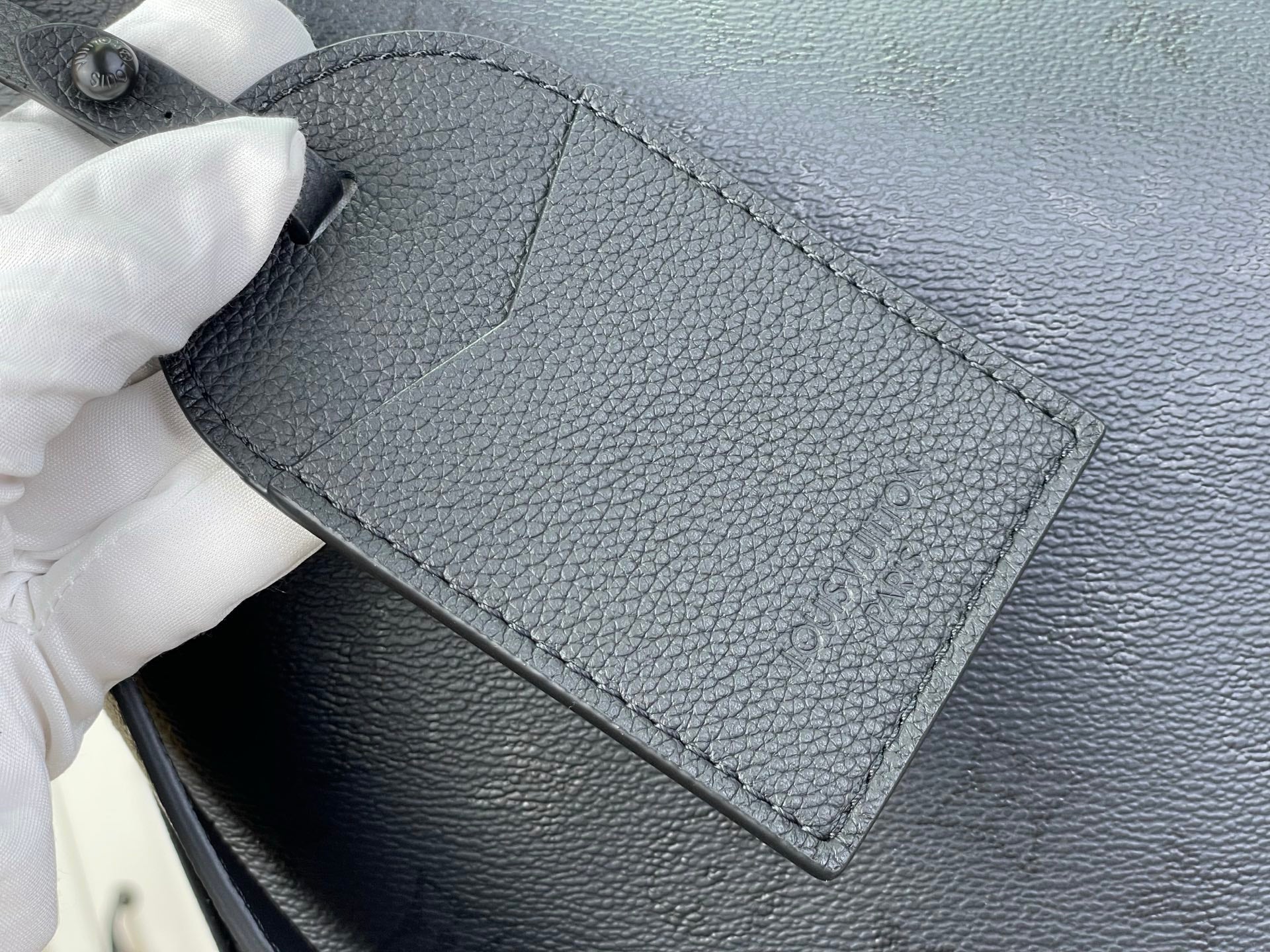Louis Vuitton hobo bag close-up of interior pocket panel and stitched edge