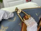 Louis Vuitton bag zipper pull and gold D-ring hardware with blue monogram and tan strap