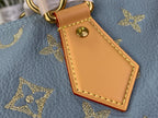 Louis Vuitton tan leather luggage-tag charm with gold button detail on light blue monogram