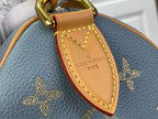 Louis Vuitton tan luggage tag charm reading “LOUIS VUITON PARIS” on light blue monogram bag