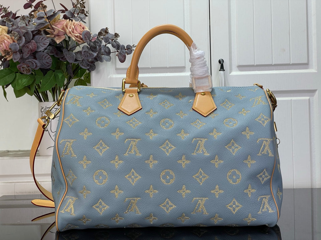 Louis Vuitton light blue monogram tote bag with tan leather top handles and hanging tags