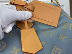 Louis Vuitton light blue monogram tote bag with tan leather tag charms and gold stitching