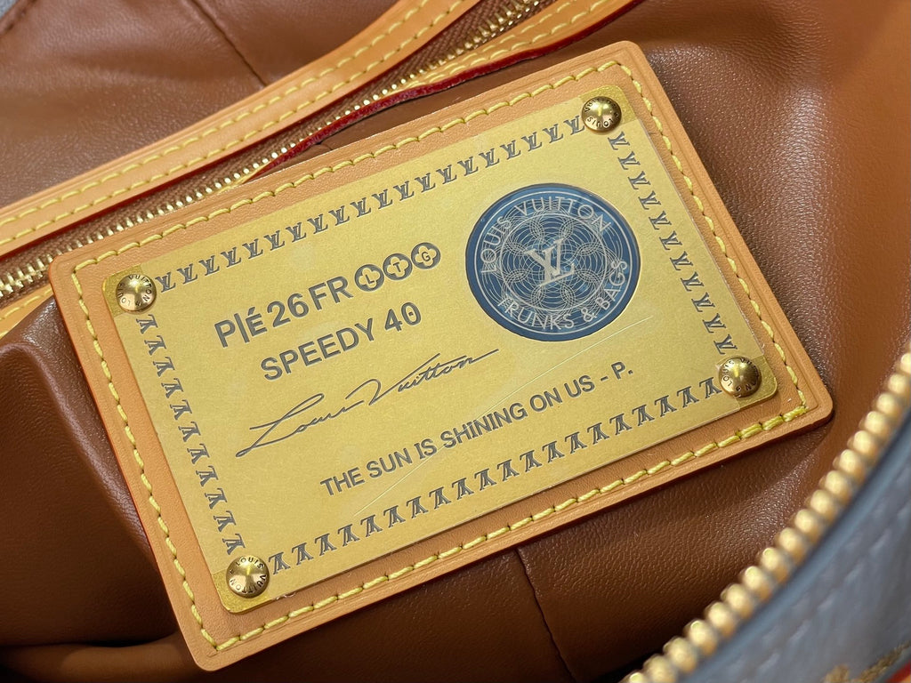 Louis Vuitton bag leather label patch with printed text and gold emblem hardware corner studs