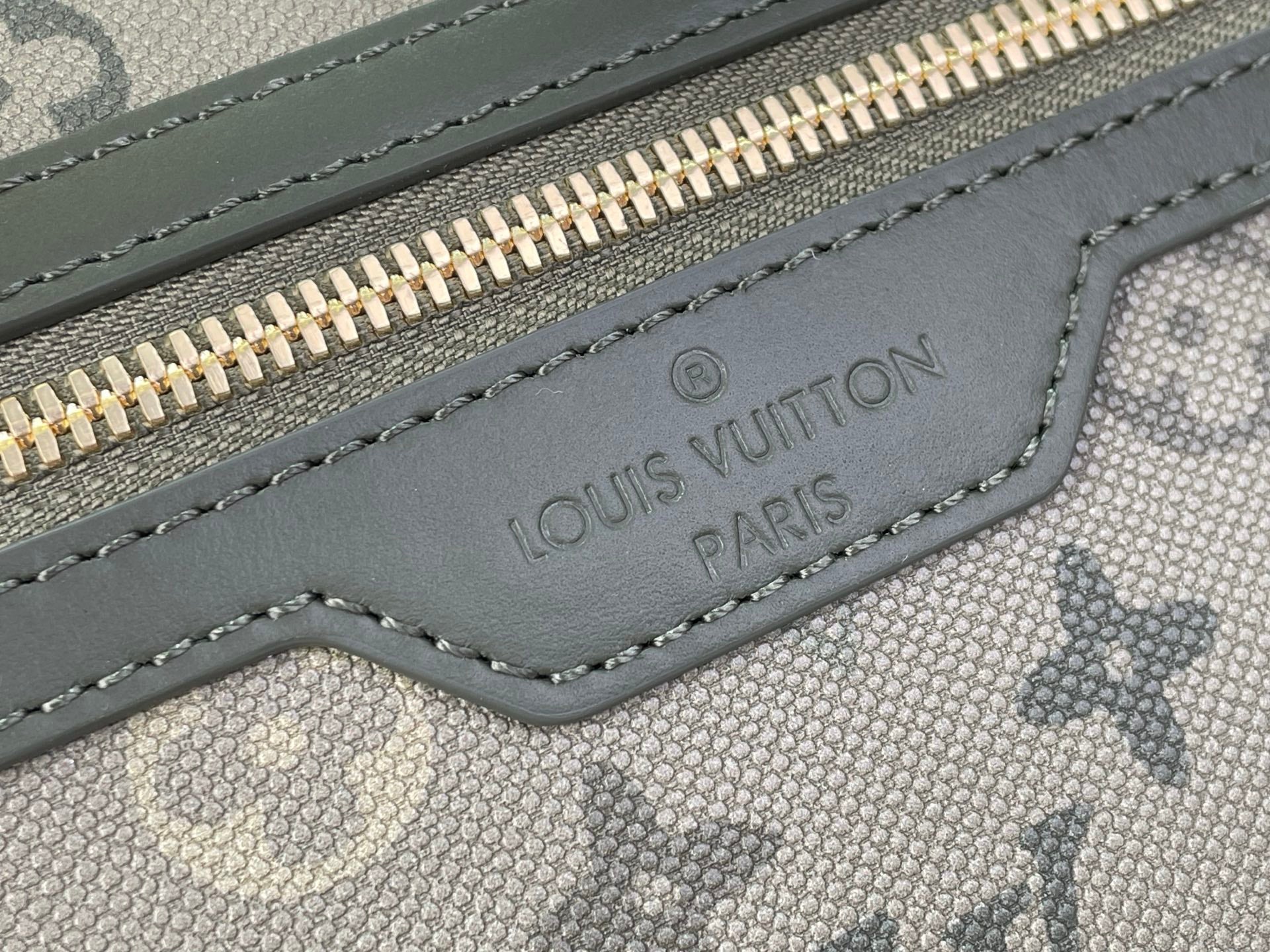 Louis Vuitton Paris logo stamp on gray fabric zipper tab with stitching