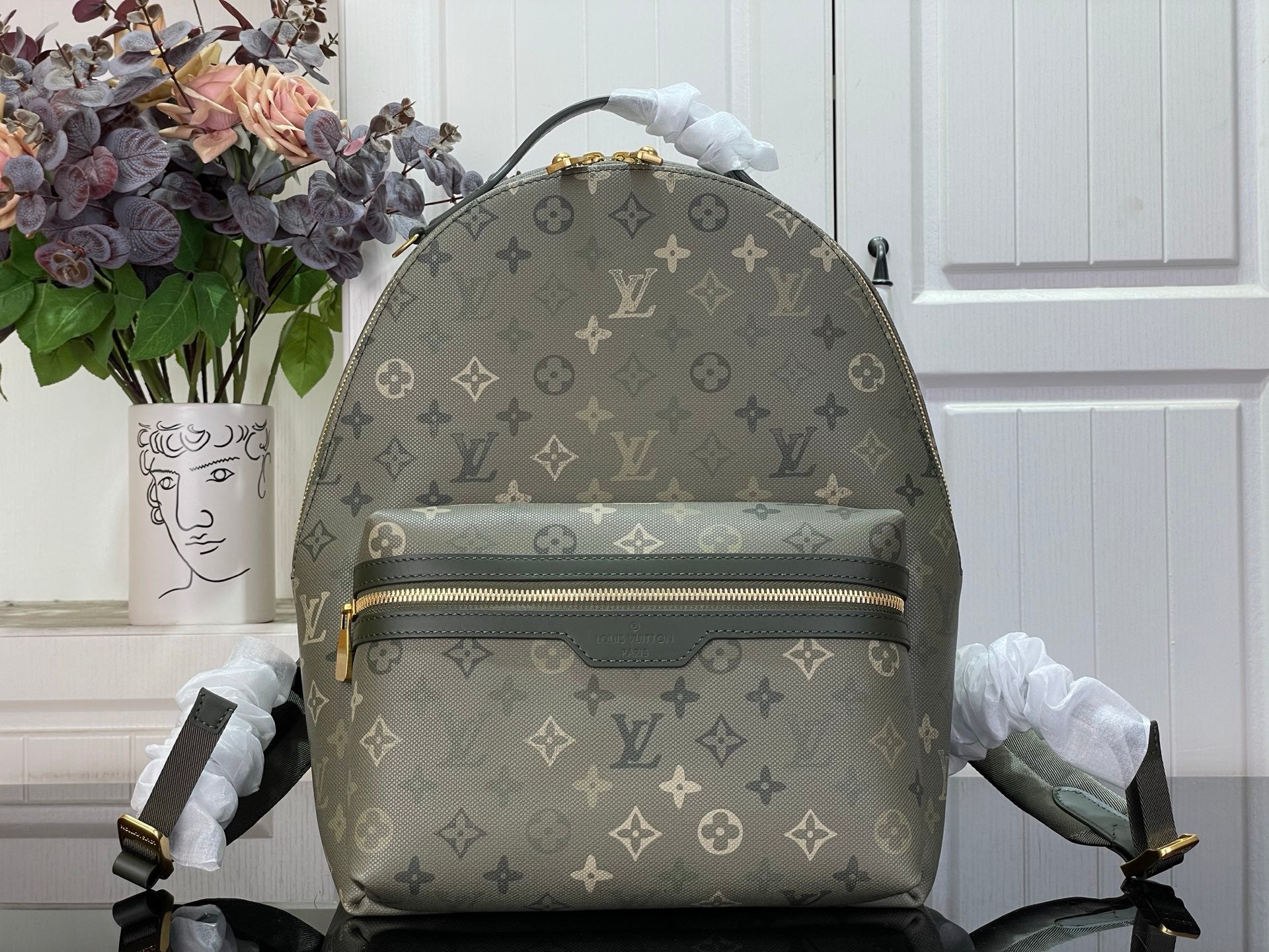 Louis Vuitton monogram backpack with top handle and front zip, gray-green canvas
