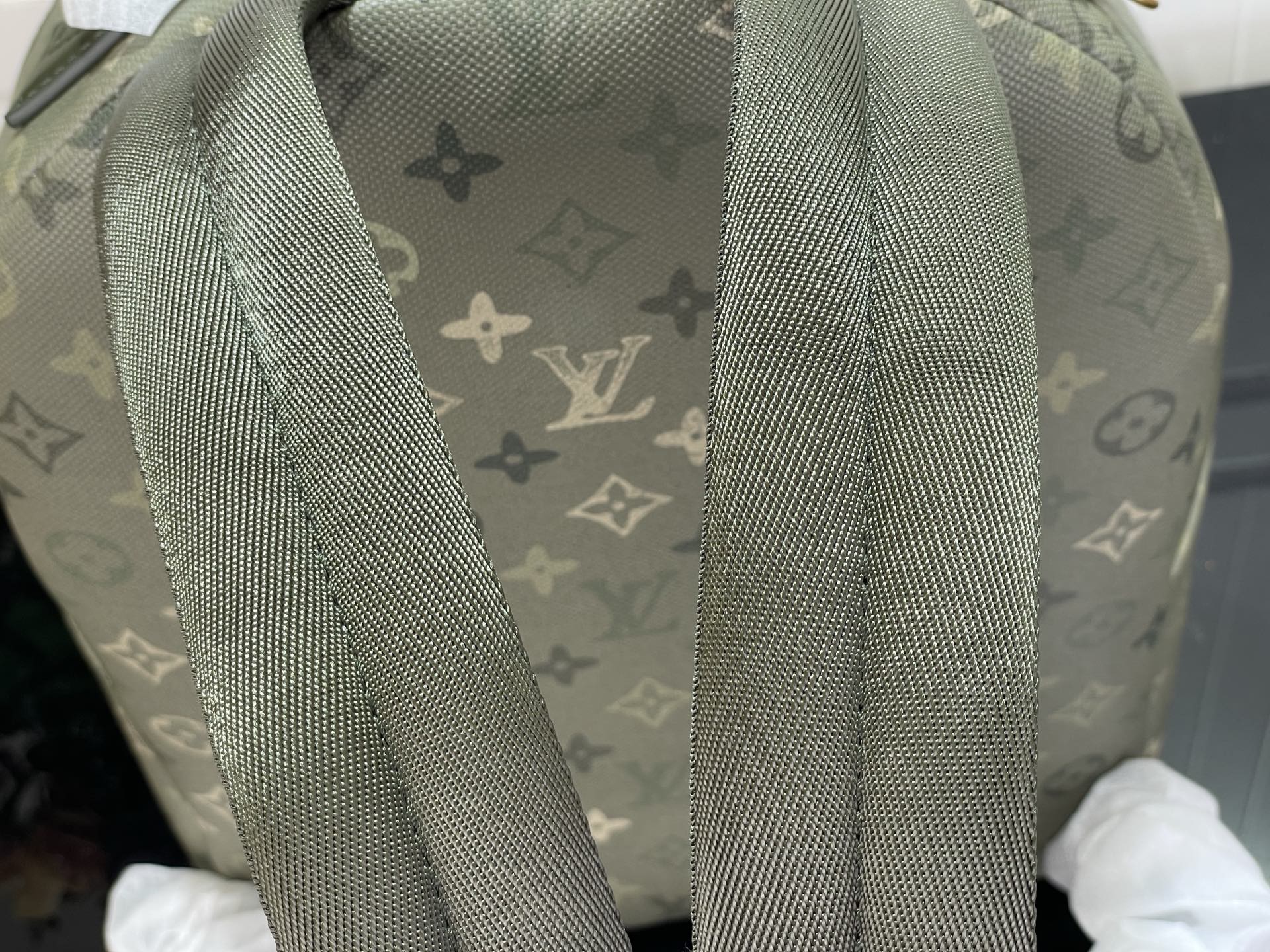 Louis Vuitton monogram backpack with textured gray-green shoulder straps