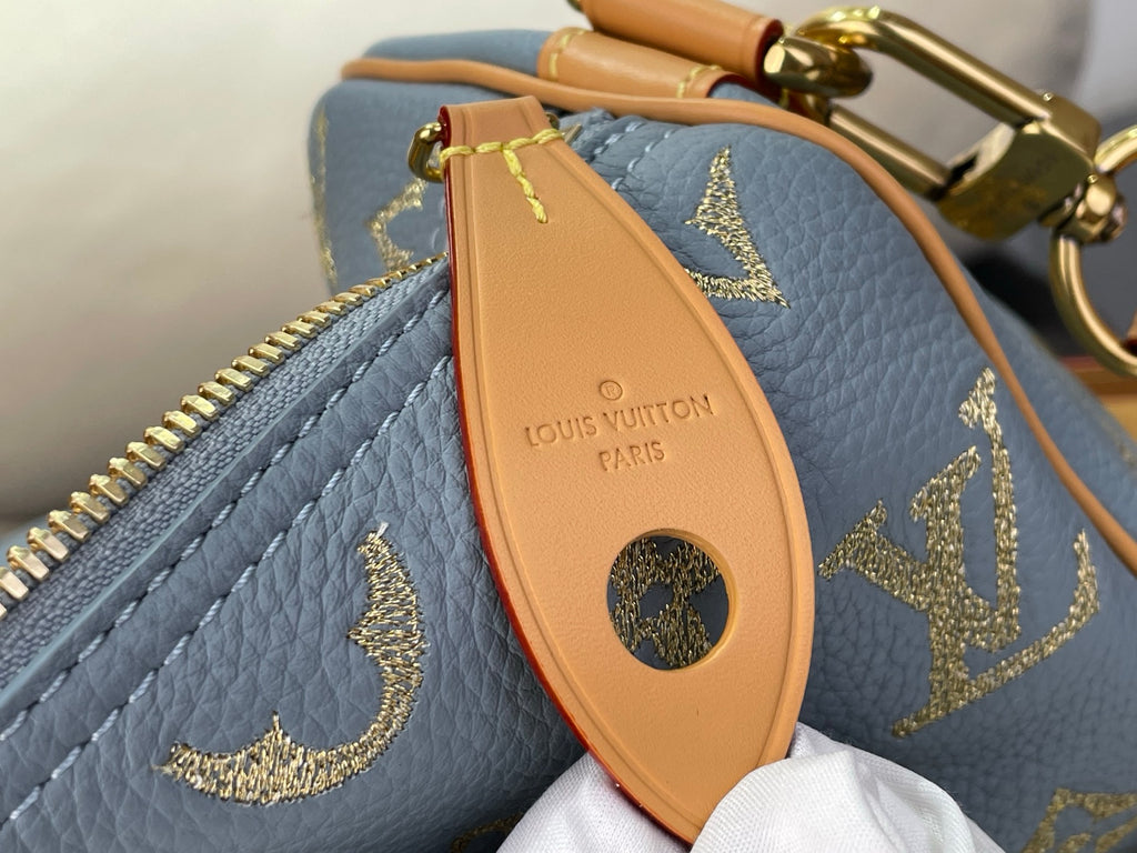 Louis Vuitton bag orange leather luggage tag with logo on light blue monogram exterior