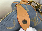 Louis Vuitton bag orange leather luggage tag with logo on light blue monogram exterior