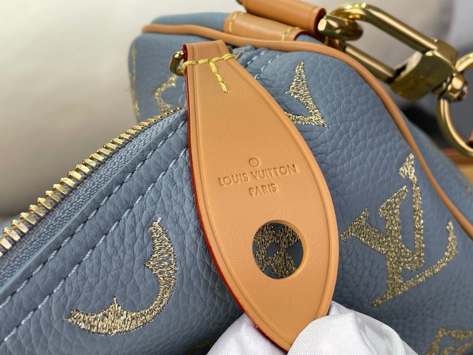 Louis Vuitton bag orange leather luggage tag with logo on light blue monogram exterior