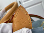 Louis Vuitton tan leather tag with embossed logo detail on light blue monogram bag