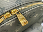 Gold zipper hardware with Louis Vuitton mark on gray-green monogram bag