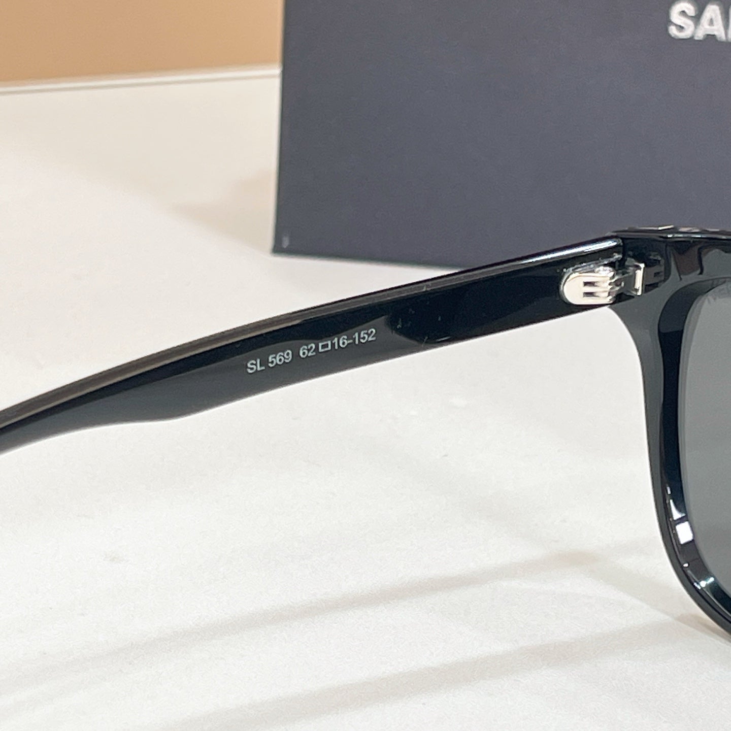 YSL black sunglasses temple close-up with model numbers printed on arm