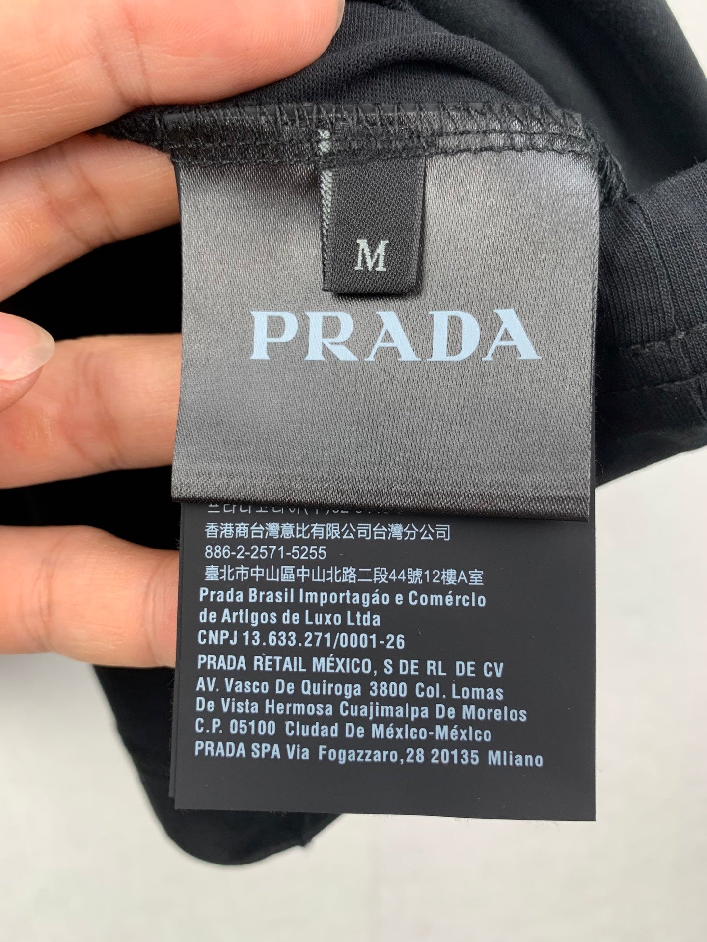Prada short in dark fabric with size M tag and PRADA logo patch