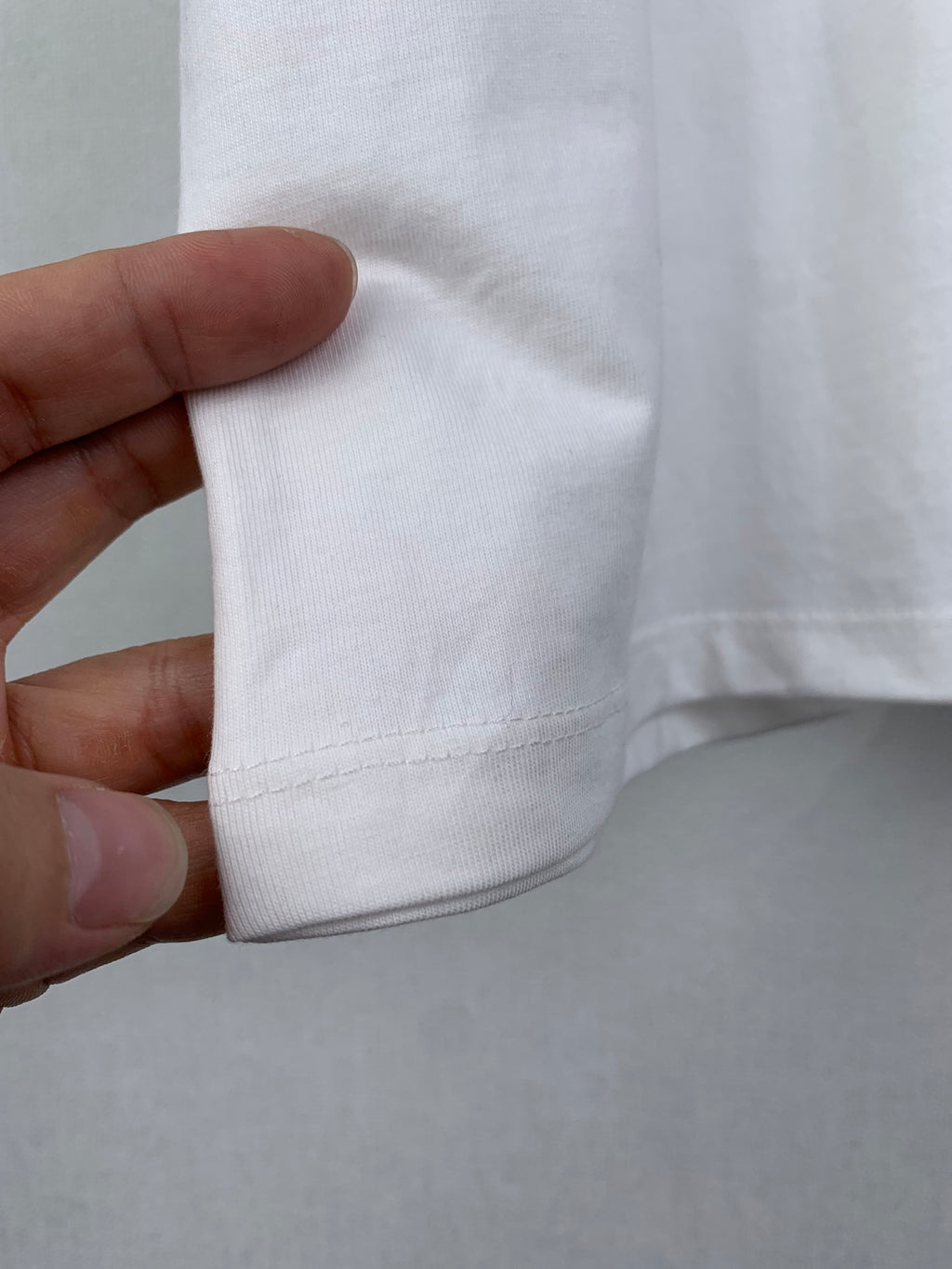 Dior short-sleeve T-shirt, cuff/hem seam close-up in white