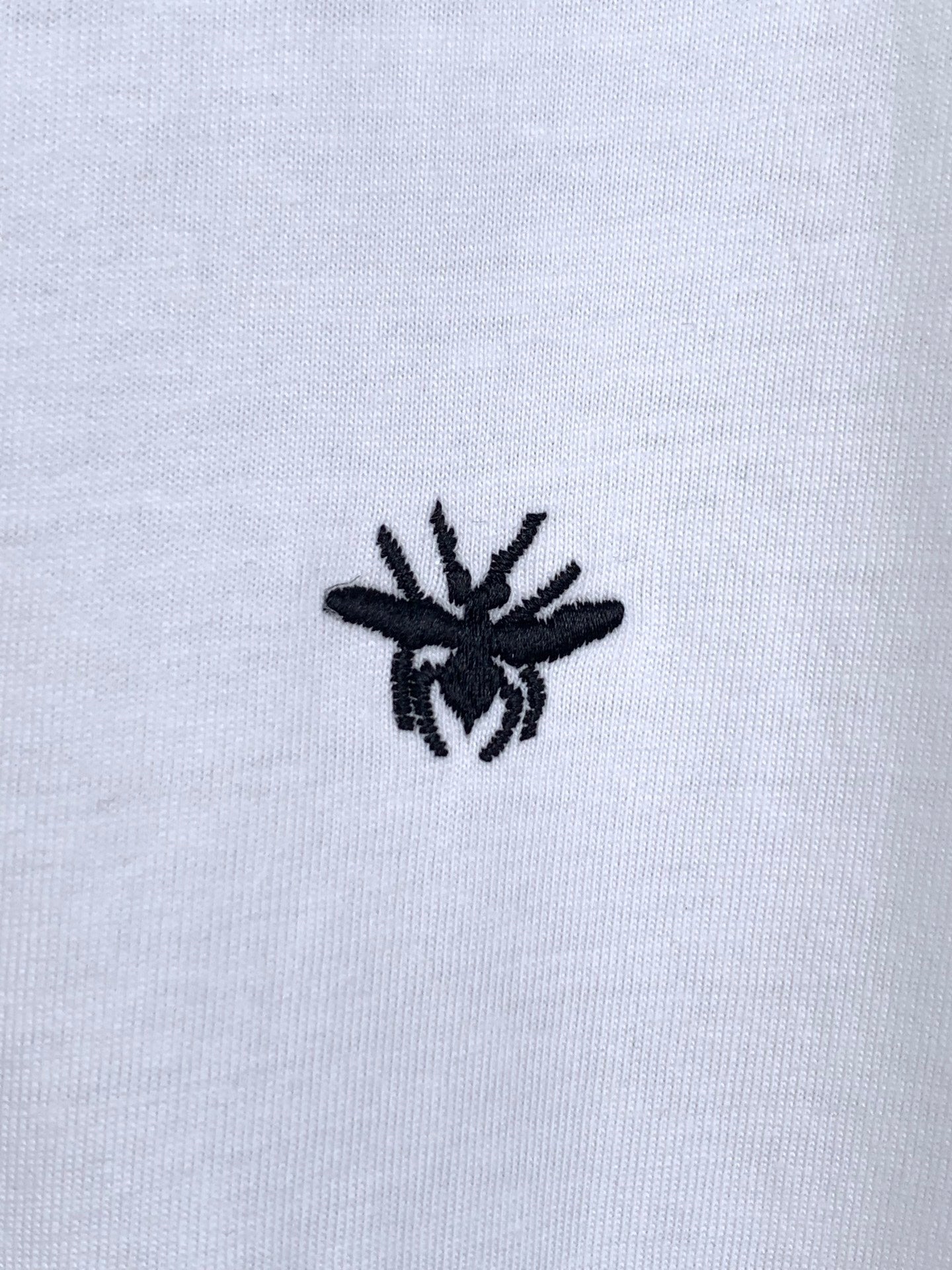 Dior short-sleeve T-shirt, small black emblem detail on white fabric