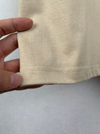 Beige T-shirt hem with stitched fold detail