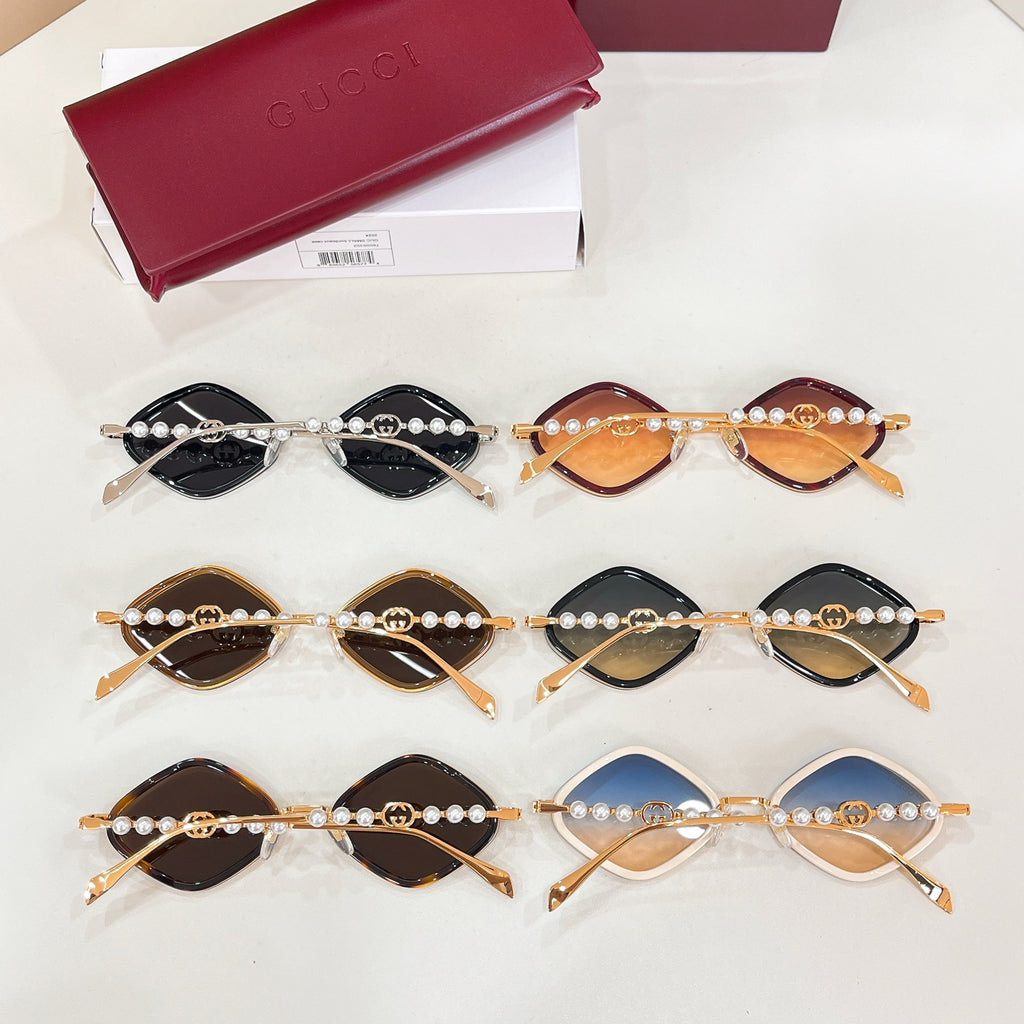 Assorted designer sunglasses with gold frames, pearl trim, and tinted lenses